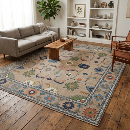 Neutral vintage Oushak wool area rug styled in a modern living room with a beige field, dusty blue border, and traditional floral motifs.