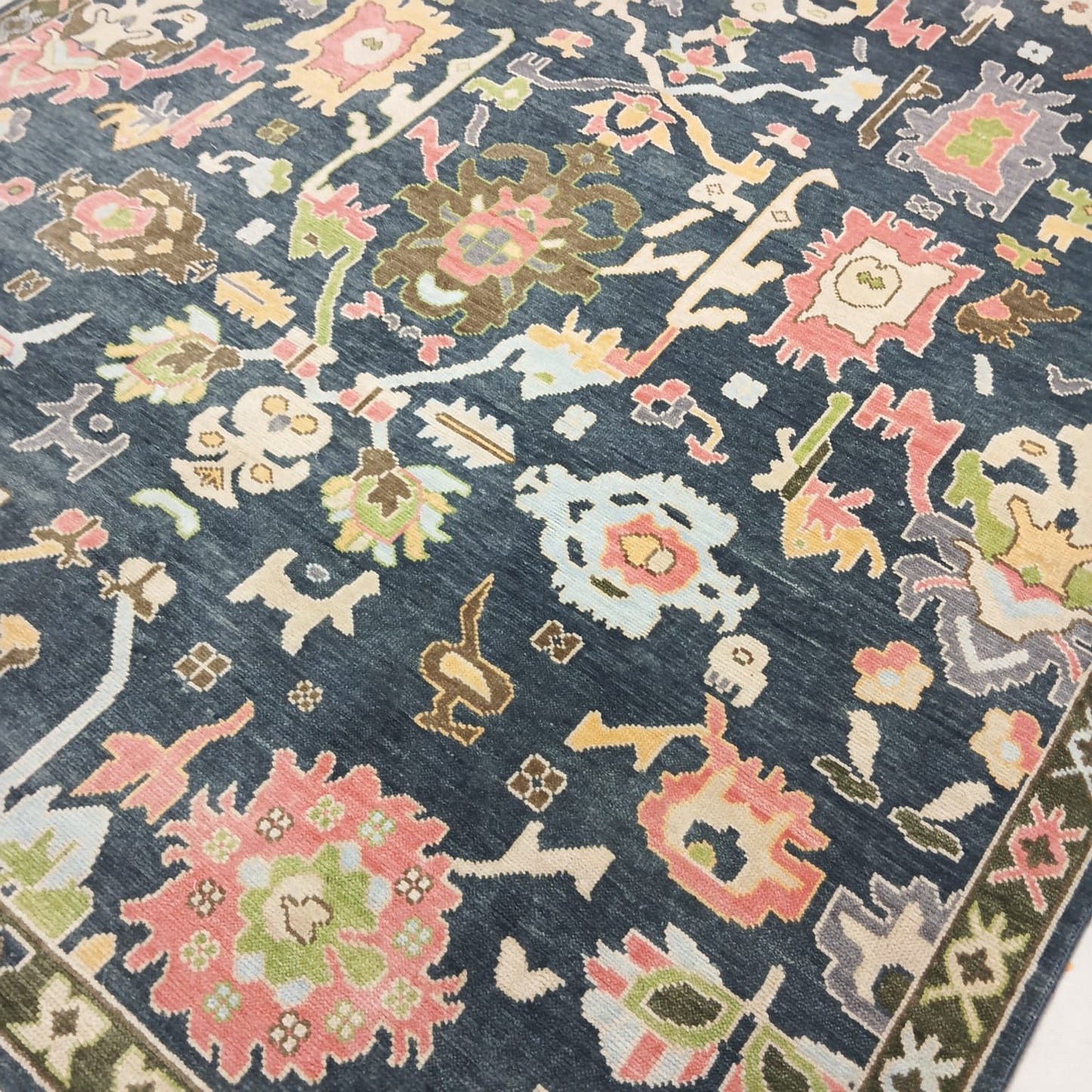 Corner detail showing craftsmanship of handmade Oushak rug