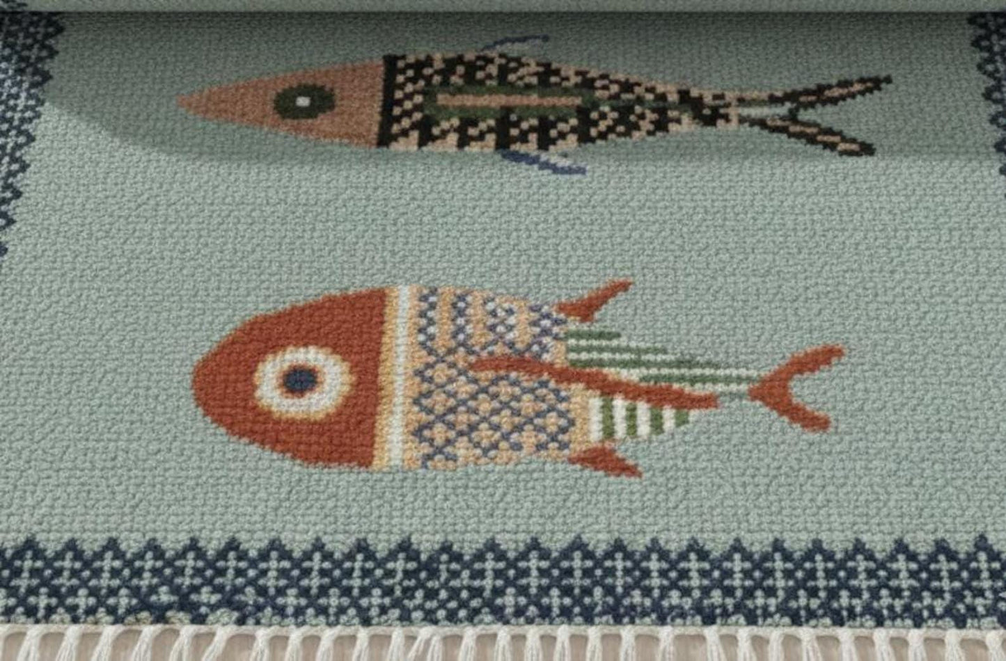 oushakaura Close-up of handmade fish motif runner rug with detailed artisan woven coastal pattern