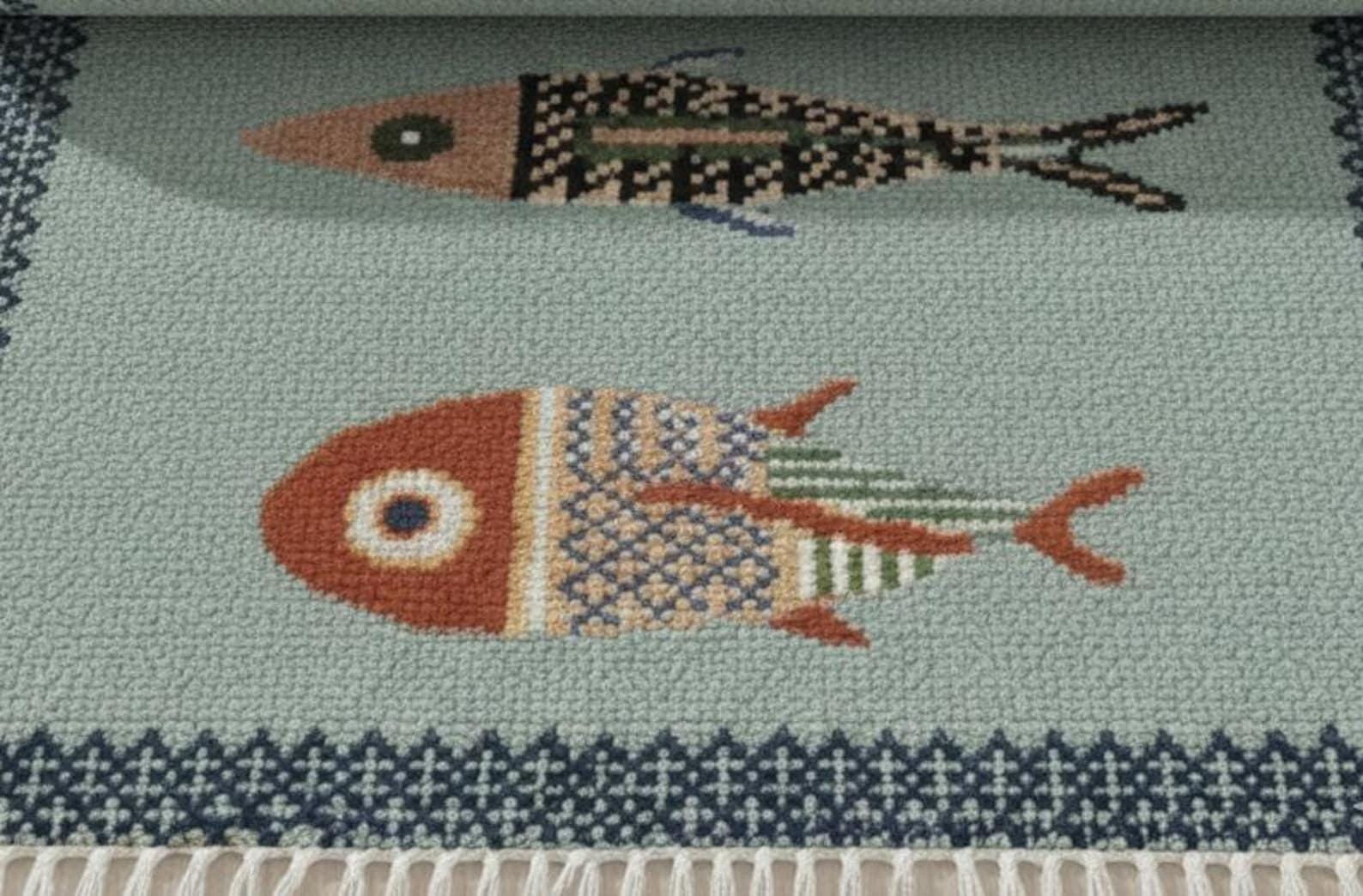 oushakaura Close-up of handmade fish motif runner rug with detailed artisan woven coastal pattern