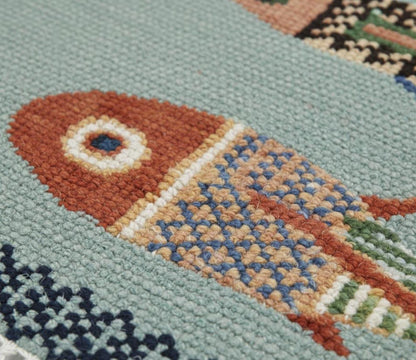oushakaura Close-up of a colorful fish pattern on a textured fabric background