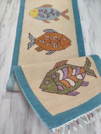 Long handmade hallway runner rug with fish motifs by Oushakaura for coastal home decor