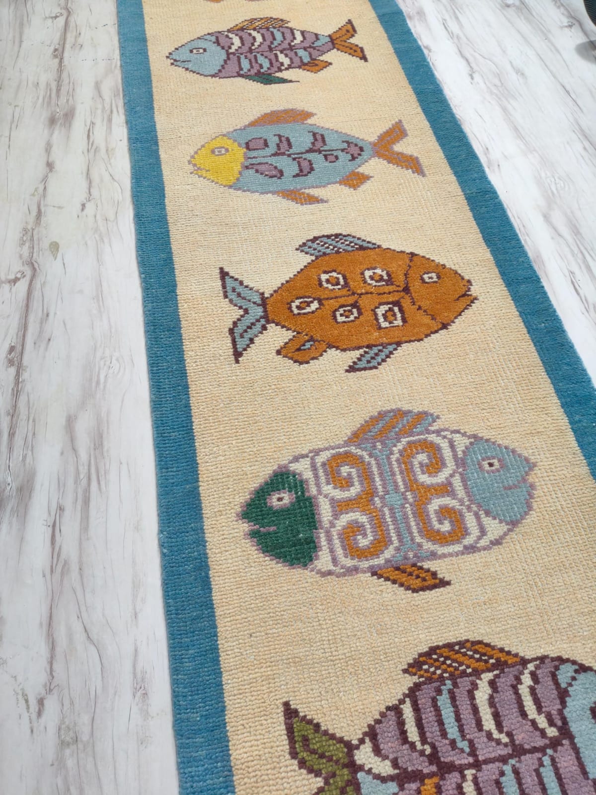 Oushakaura nautical wool runner rug with decorative fish artwork and handcrafted woven finish