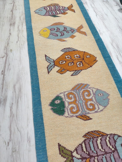 Oushakaura nautical wool runner rug with decorative fish artwork and handcrafted woven finish
