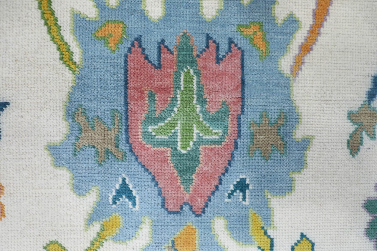 Close-up of a needlepoint design with geometric patterns and colors.