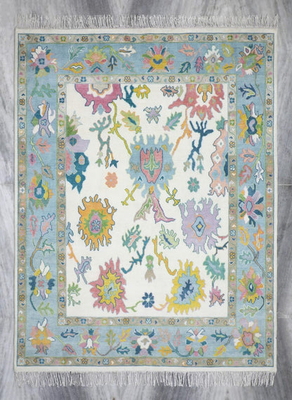 Pastel blue Oushak rug with ivory center and colorful vintage floral pattern