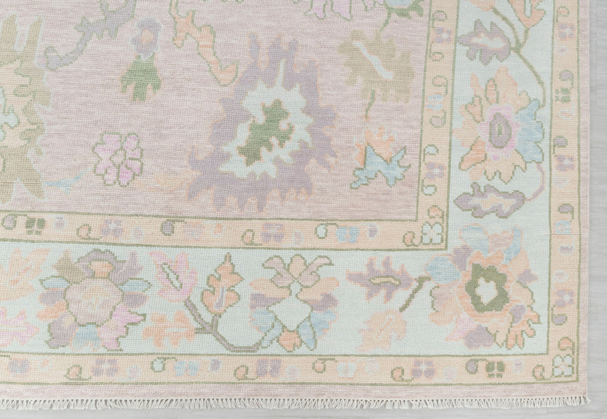 Close-up of pastel floral runner rug showing decorative border and botanical motifs