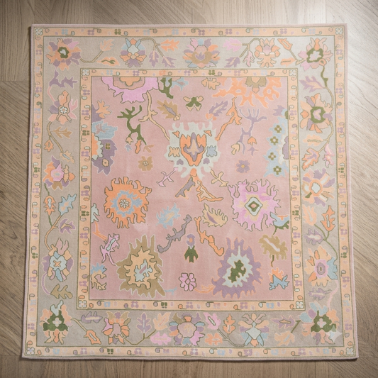 Pastel floral rug in pink with multicolor botanical flower design and decorative border