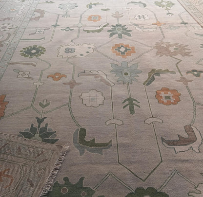 Close up of sage green and blue Oushak floral rug pattern