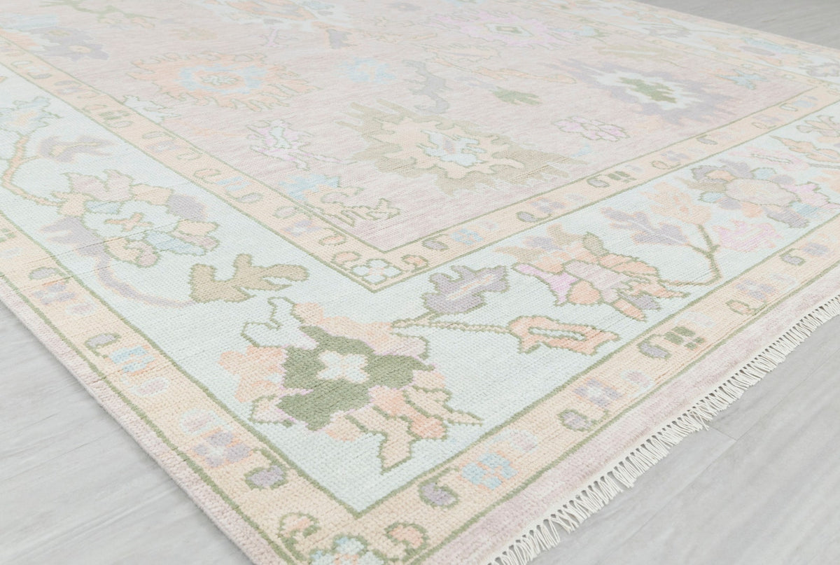 Pastel traditional runner rug showing floral border, soft colors and fringed edge