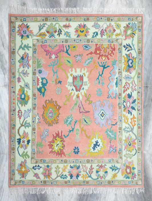 Pastel peach Oushak rug with colorful vintage floral pattern and ivory border