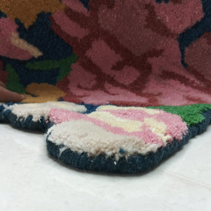 Close-up of raised pink and burgundy floral rug pile