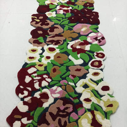 Close-up of raised pink and burgundy floral rug pile