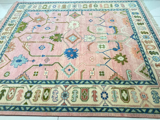 Low pile thickness detail of handmade blush pink wool rug.