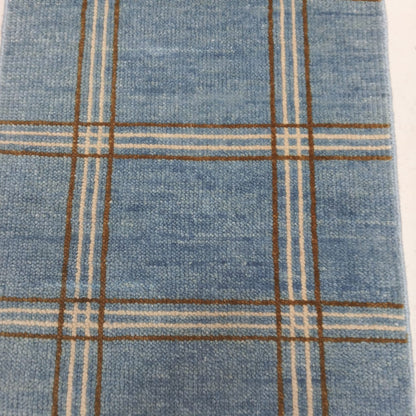 Detail of plaid pattern on modern blue wool area rug