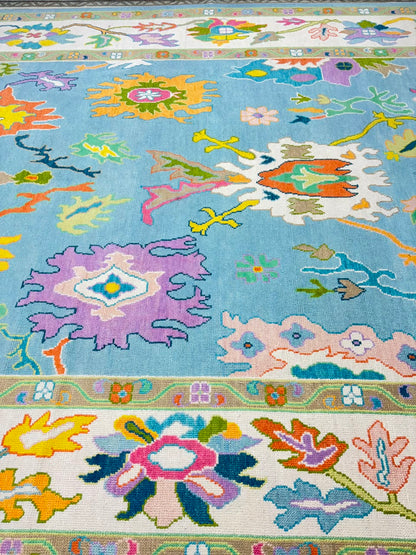 Detailed texture of premium handmade wool Oushak rug with colorful botanical design