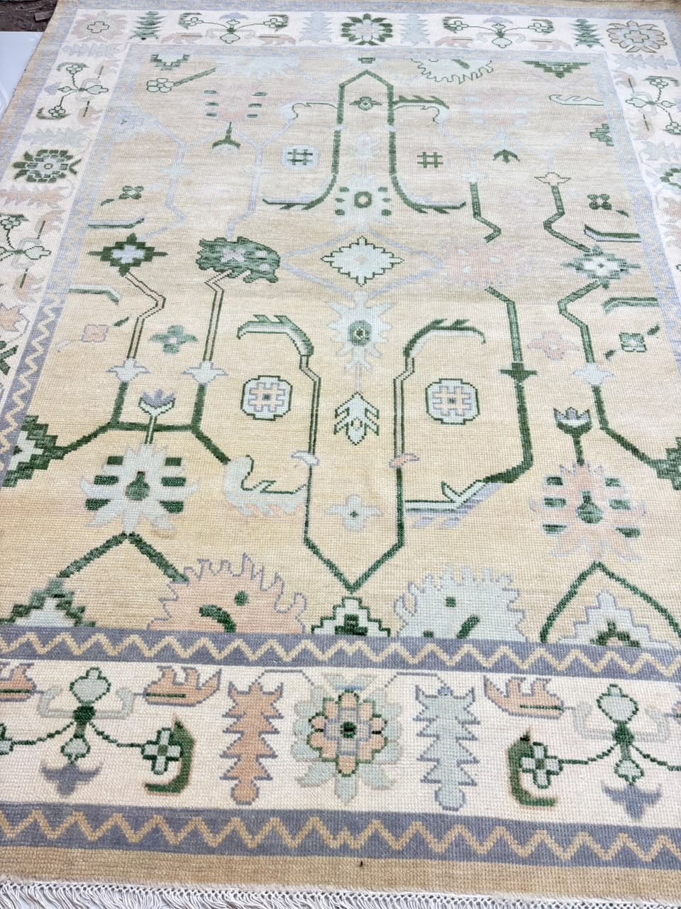 Sage green and beige floral Oushak-inspired area rug with traditional design