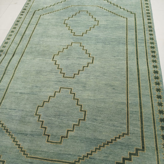 Handmade sage green wool rug with minimal geometric diamond pattern