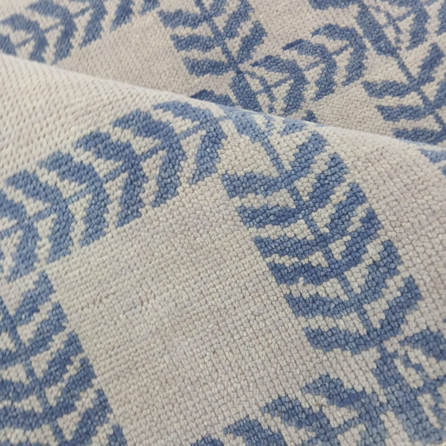 Blue and ivory Scandinavian geometric wool rug showing handwoven grid pattern