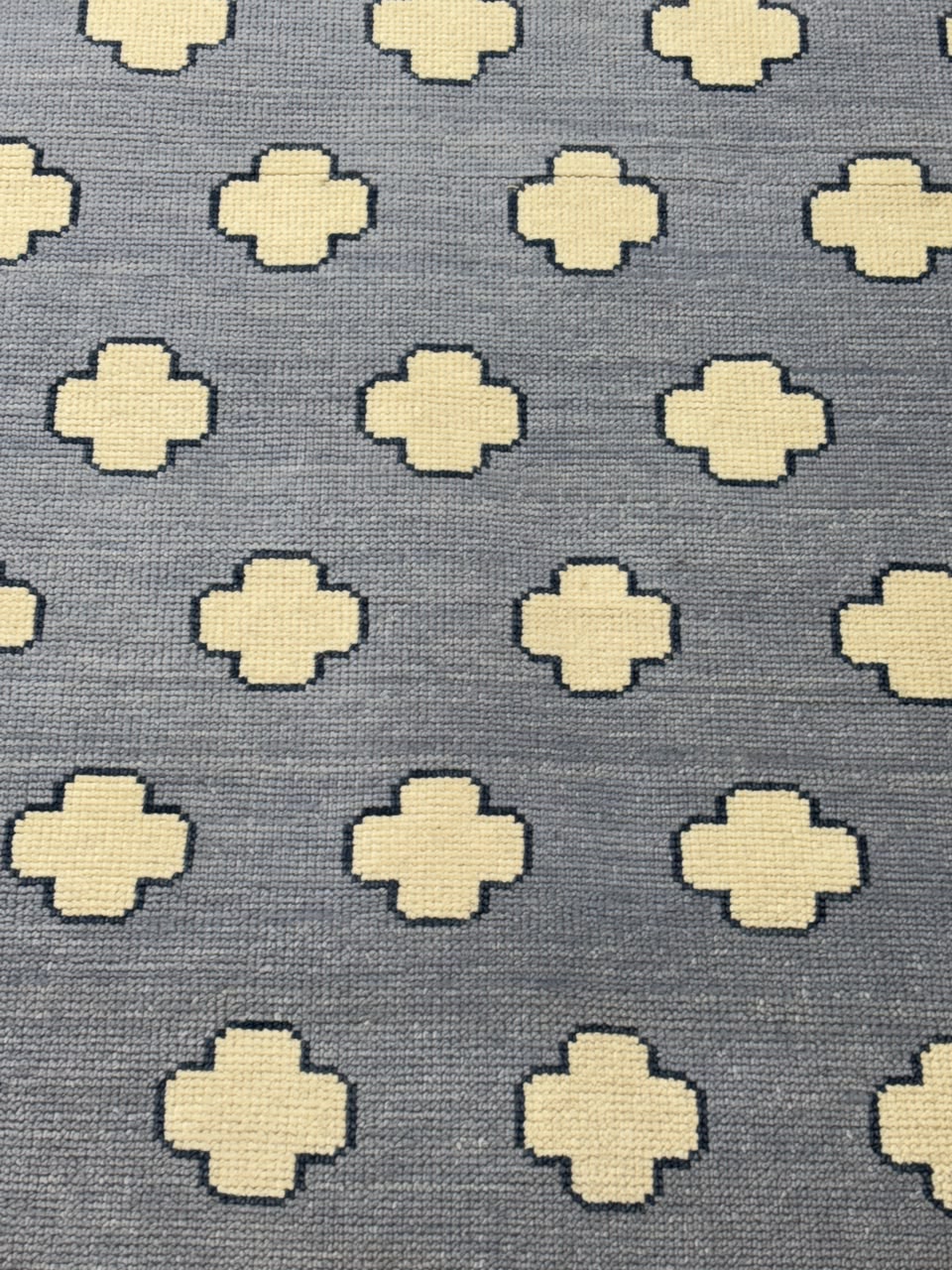 Close-up of the soft low-pile wool surface on a modern Scandinavian area rug.