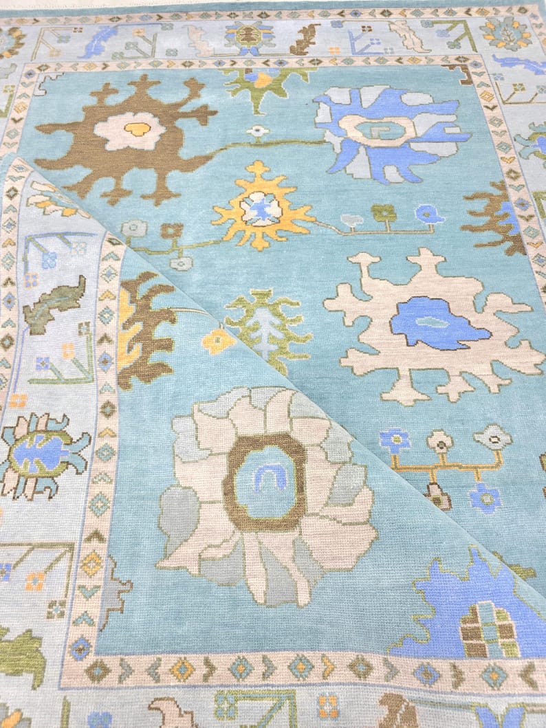 Folded corner detail showing pile thickness of sky blue hand tufted rug