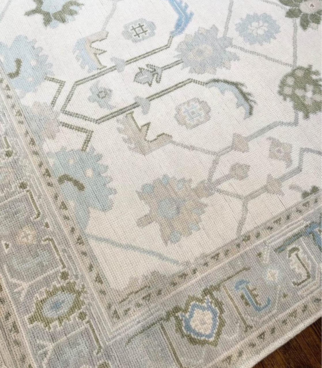 Soft blue and sage green pattern detail on handwoven Oushak wool rug
