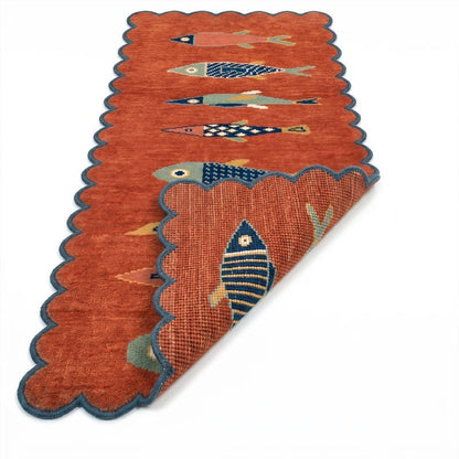 Terracotta fish runner rug showing scalloped edge and reverse side construction