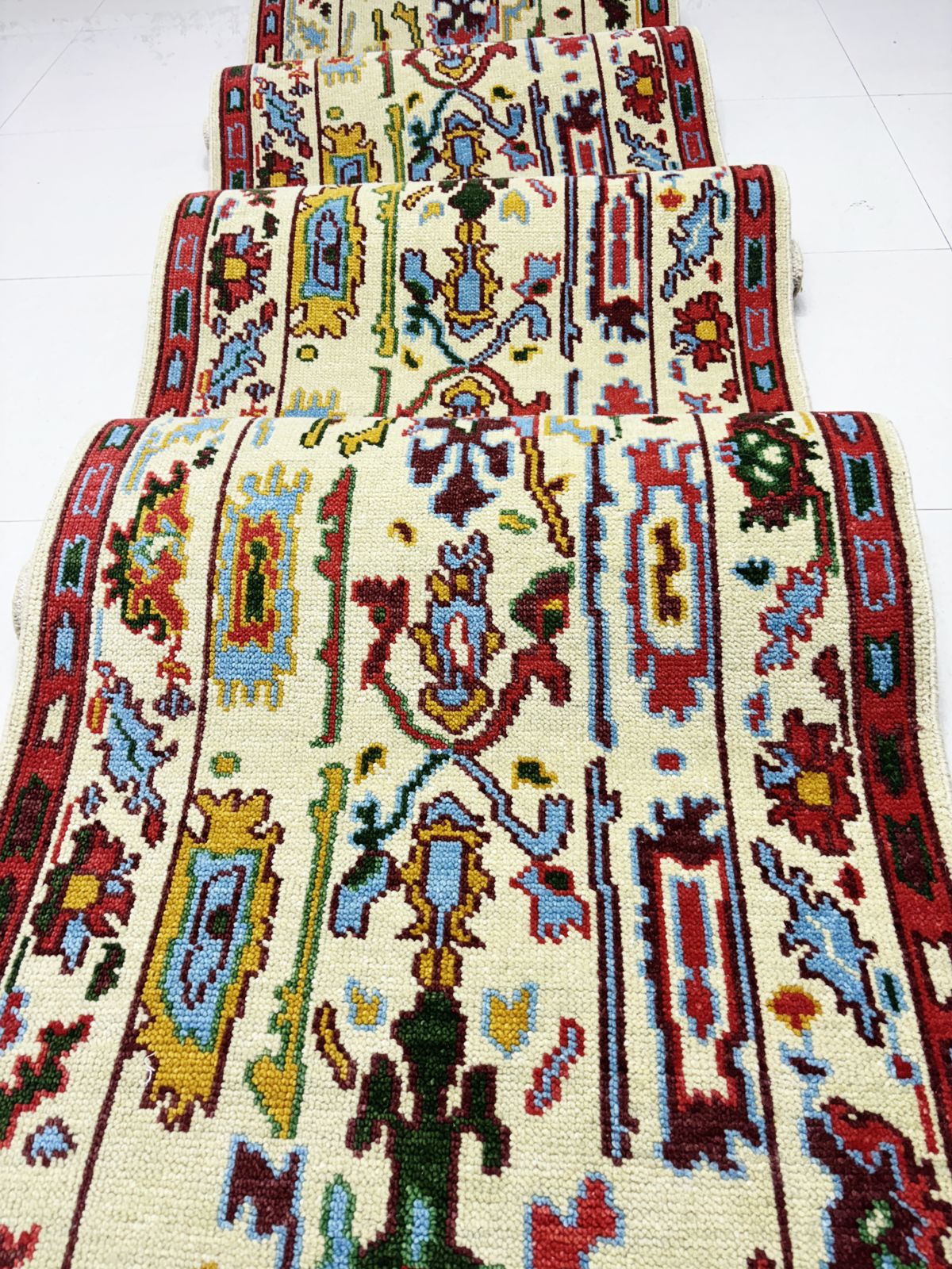 Front view of vintage cream and red Oushak runner rug for hallway decor