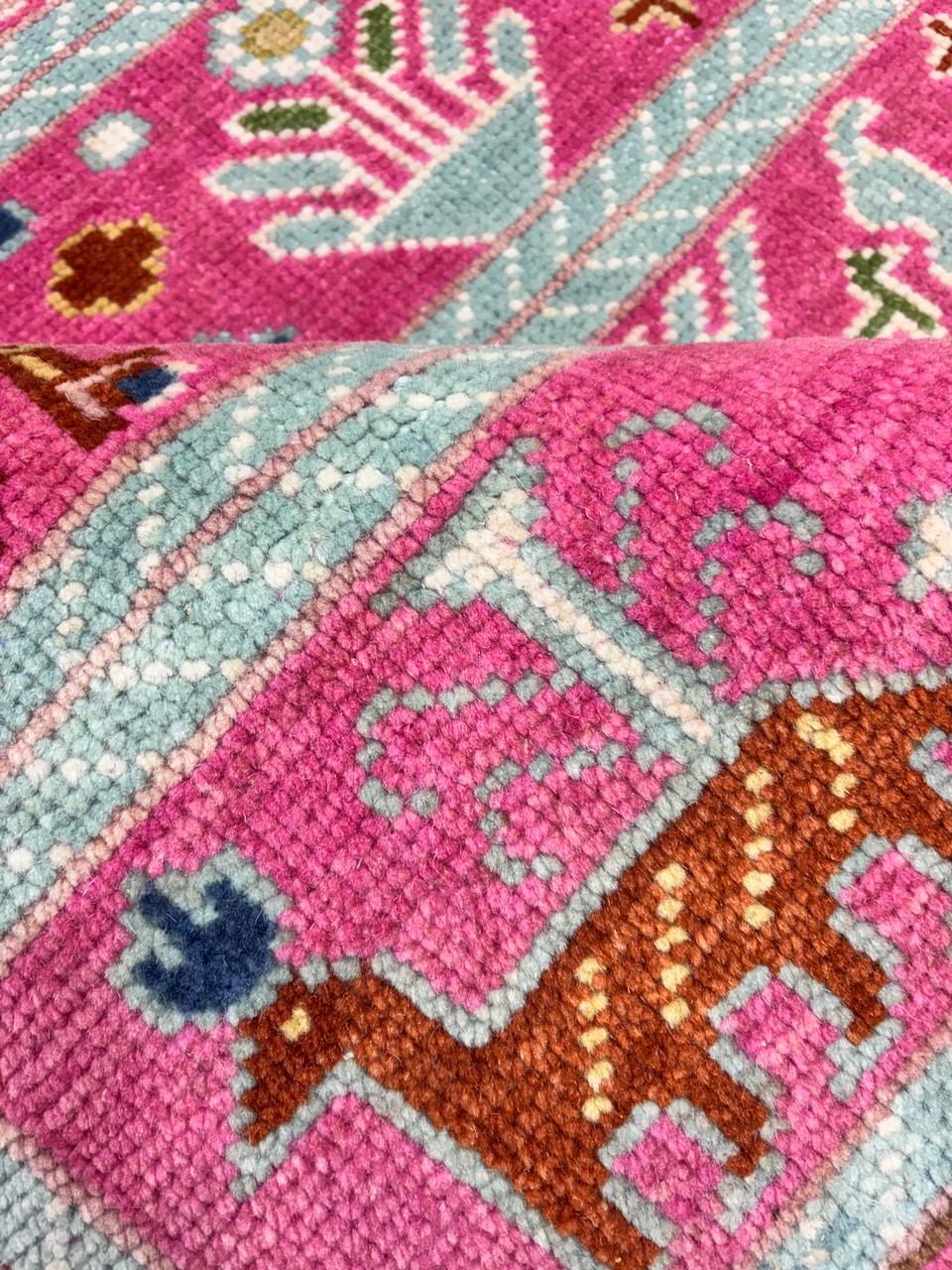Close-up texture of handwoven tribal Oushak wool rug pattern