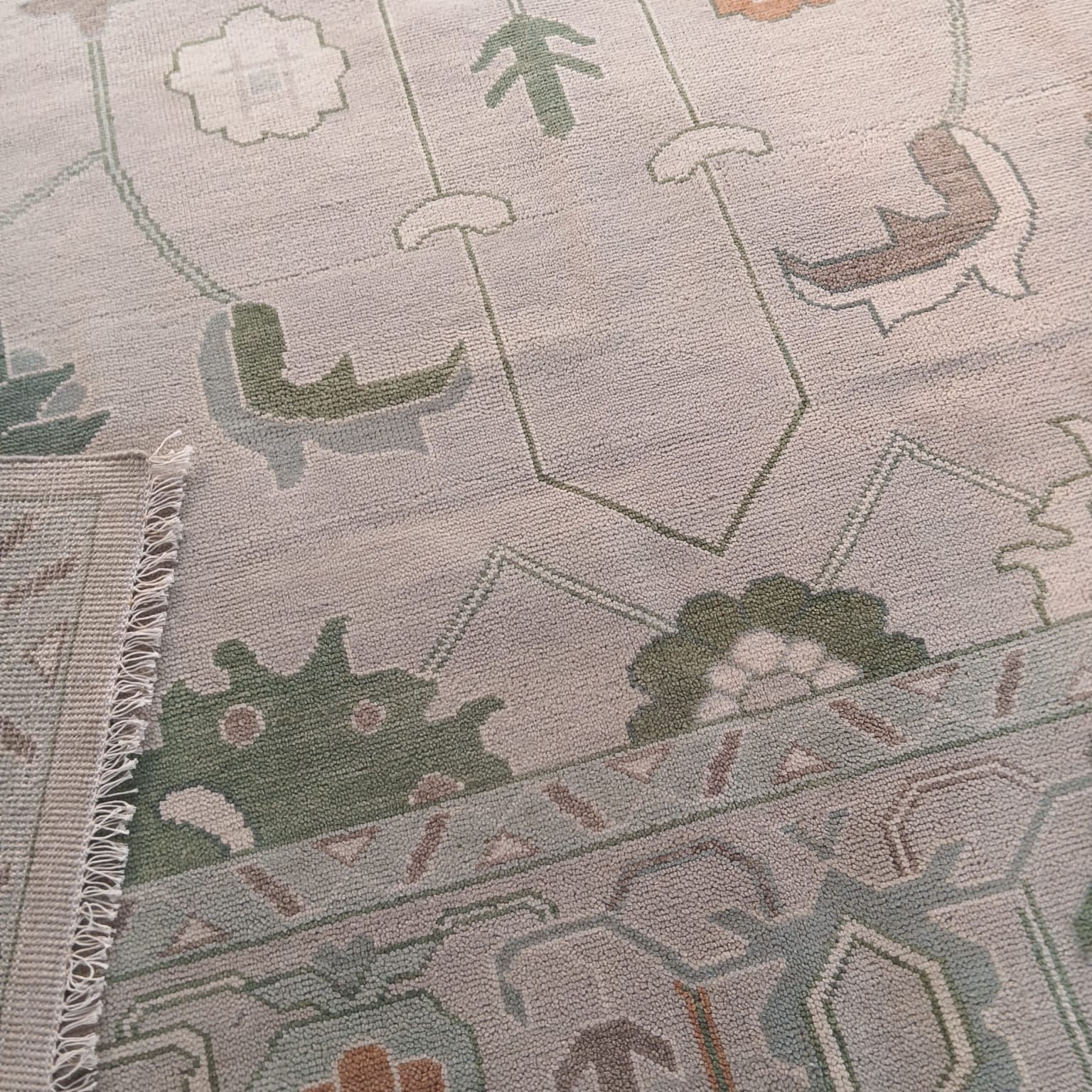 Detailed view of handwoven Turkish inspired floral wool rug