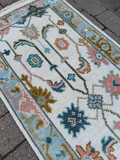 Angled view of a handcrafted wool Oushak runner rug designed for hallways and entryways.