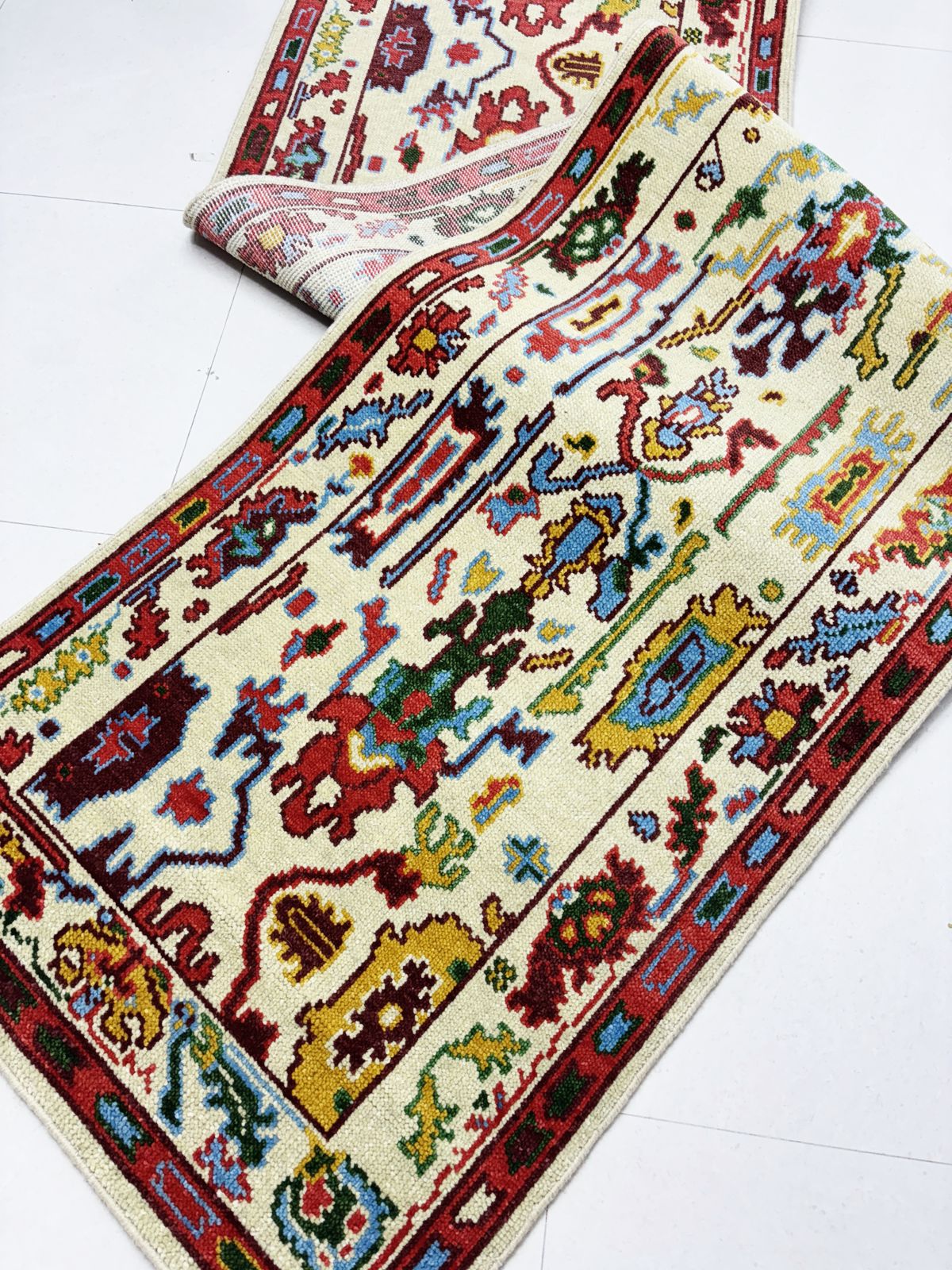 Corner detail of handmade vintage runner rug with Turkish-inspired border