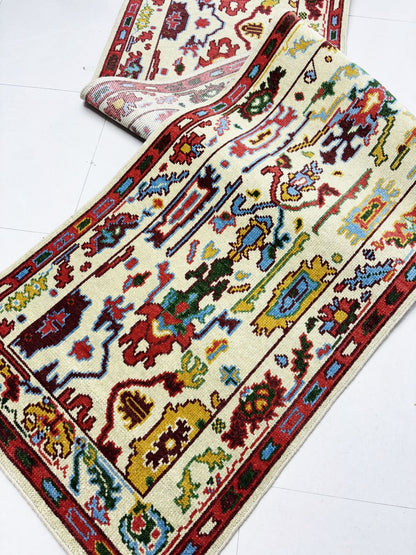 Corner detail of handmade vintage runner rug with Turkish-inspired border