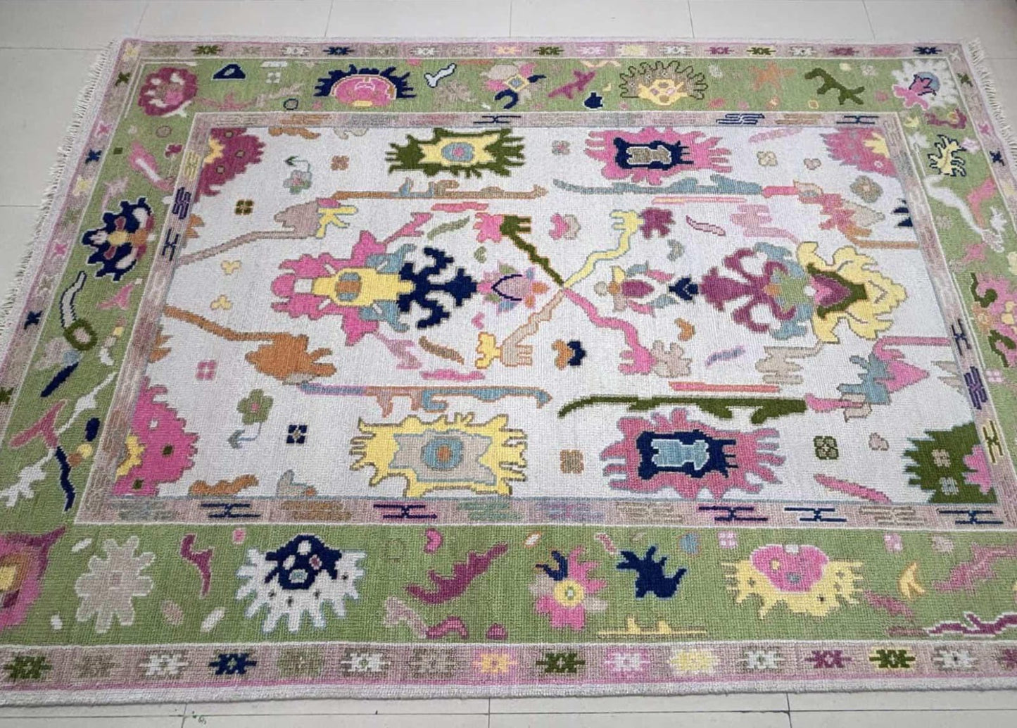Detailed texture view of handmade pastel wool rug with colorful Turkish inspired patterns