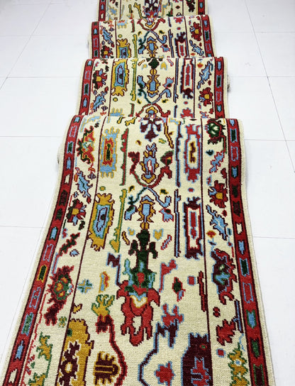 Long Oushak hallway runner rug in cream red and blue tribal design